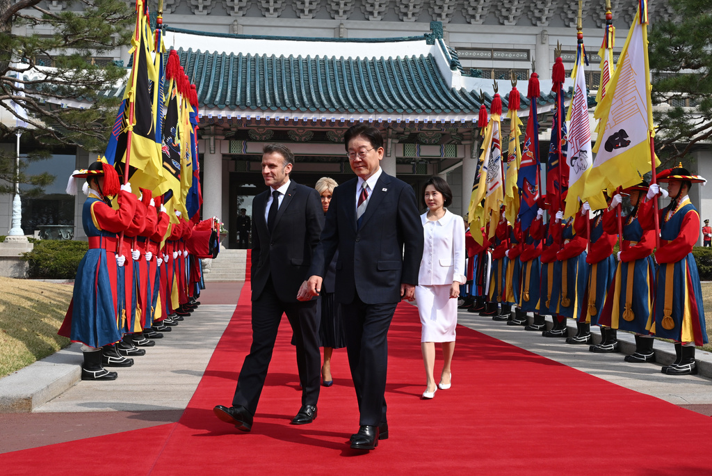 French President Emmanuel Macron, front left, his wife Brigitte Macron, back center, and South Korean President Lee Jae Myung, front right, and his wife Kim Hea Kyung, right, attend the welcome ceremony at the presidential Blue House in Seoul Friday, April 3, 2026. (Jung Yeon-je /Pool Photo via AP)