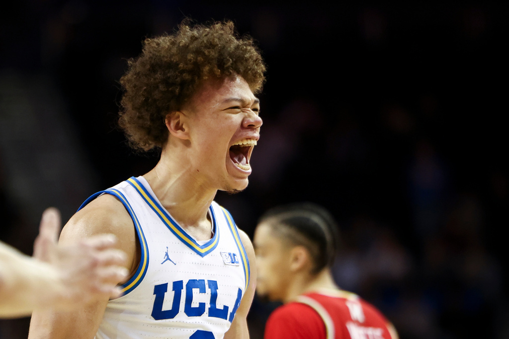 UCLA guard Trent Perry, left, reacts after a play as Maryland guard Isaiah Watts, right, looks on during the first half of an NCAA college basketball game, Saturday, Jan. 10, 2026, in Los Angeles. (AP Photo/Jessie Alcheh)