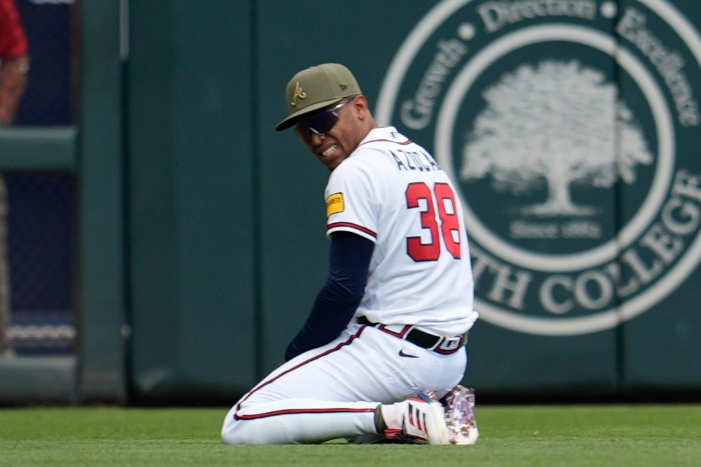 Atlanta Braves right fielder José Azócar (38) celebrates a catch off the bat of Boston Red Sox catcher Carlos Narváez in the third inning of a baseball game, Sunday, May 17, 2026, in Atlanta. (AP Photo/Mike Stewart)