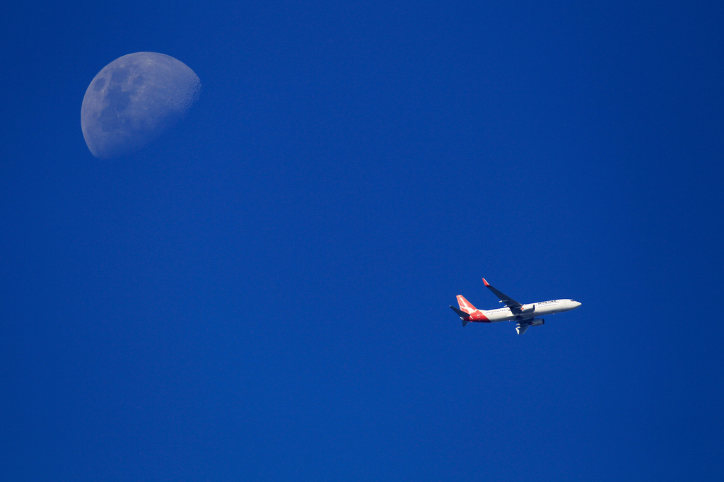 FILE - A Qantas plane flies over Sydney, on Jan. 3, 2012. (AP Photo/Rick Rycroft, File)
