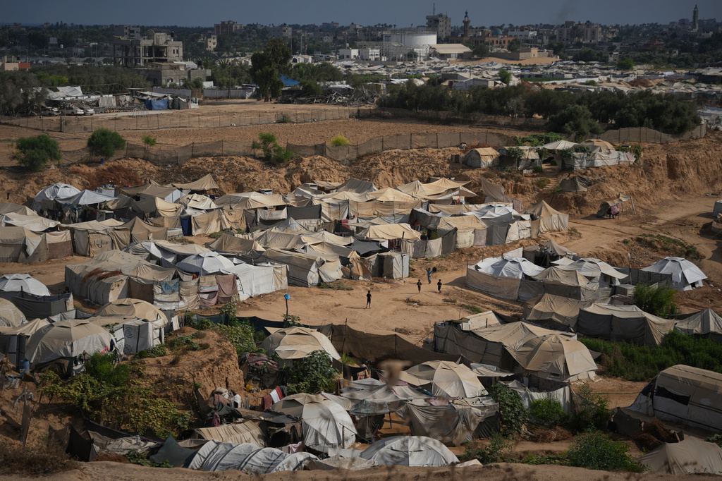 Palestinian children play in an open area at a makeshift camp for displaced people in Deir al-Balah, central Gaza Strip, Friday, Aug. 7, 2026. (AP Photo/Abdel Kareem Hana)