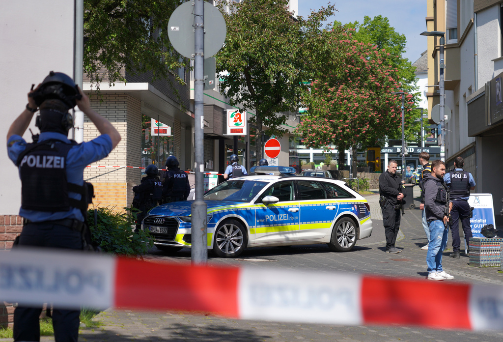 Police officers stand at the scene of a hostage-taking at a bank branch in Sinzig, Germany, Friday, May 8, 2026. (Sascha Ditscher/dpa via AP)