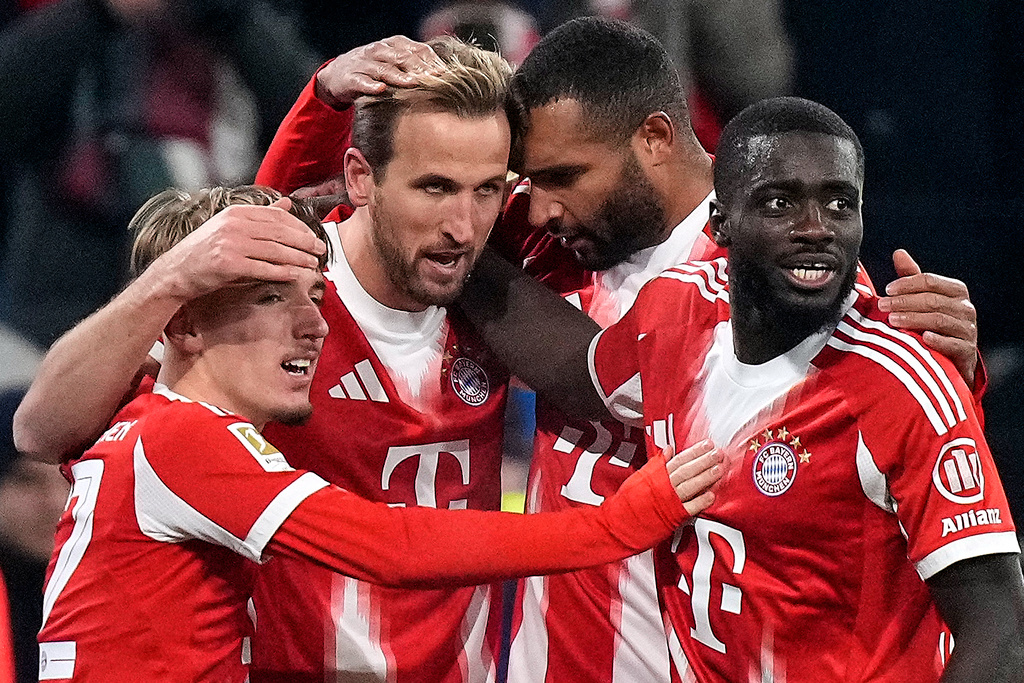 Bayern's Harry Kane, second left, Bayern's Dayot Upamecano, right, Bayern's Lennart Karl, left, and Bayern's Jonathan Tah celebrate scoring their side's fourth goal during the Bundesliga soccer match between Bayern Munich and Freiburg in Munich, Germany, Saturday, Nov. 22, 2025.(AP Photo/Matthias Schrader)