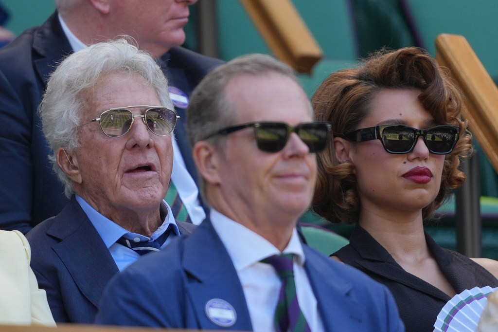 Actor Dustin Hoffman, left and Singer- songwriter Raye watches play in the women's doubles final final at Wimbledon Tennis Championships in London, Sunday, July 12, 2026. (AP Photo/Kin Cheung)