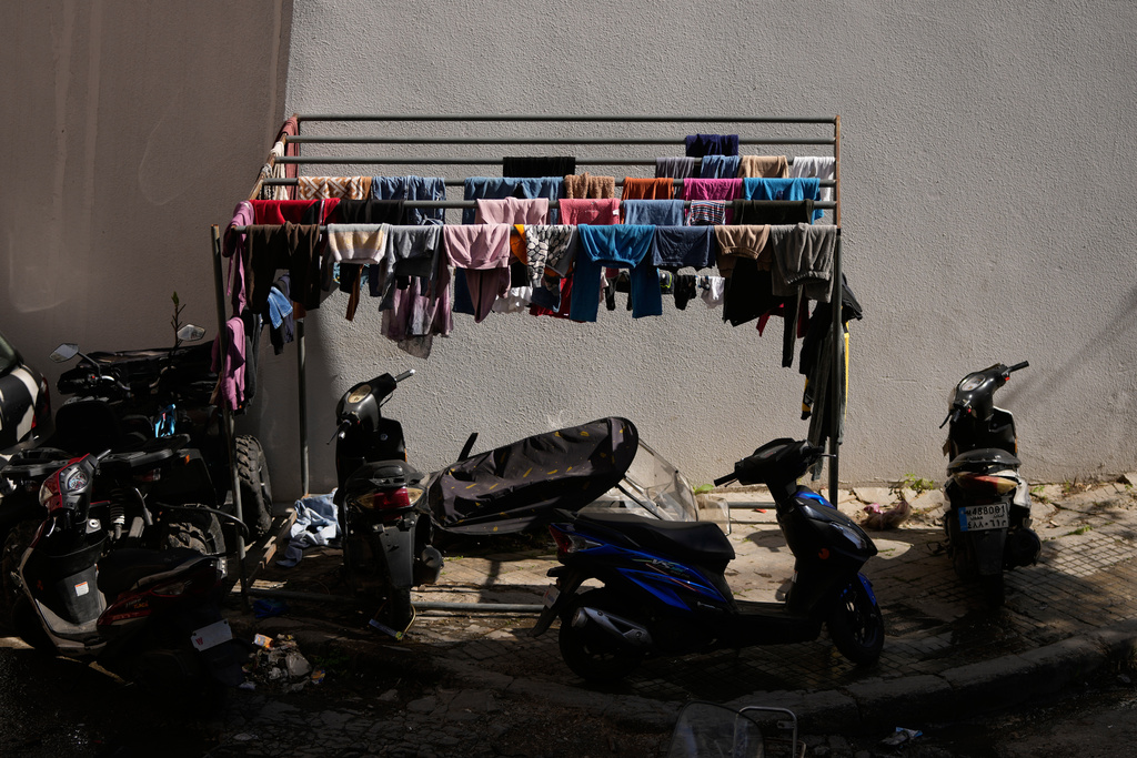 Clothes hang to dry outside a school in Beirut, used as a shelter for people displaced by Israeli airstrikes in southern Lebanon and Dahiyeh, Beirut's southern suburbs, Monday, March 9, 2026. (AP Photo/Hassan Ammar)