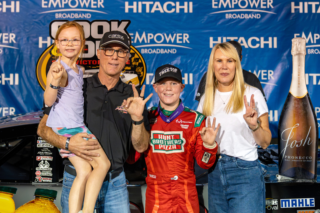 In this undated image provided by Kevin Harvick, Inc., Keelan Harvick, center, poses with his family, from left, sister Piper, father retired NASCAR driver Kevin Harvick and mother DeLana Harvick following a victory. (Adrenalens Media/Kevin Harvick, Inc. via AP)