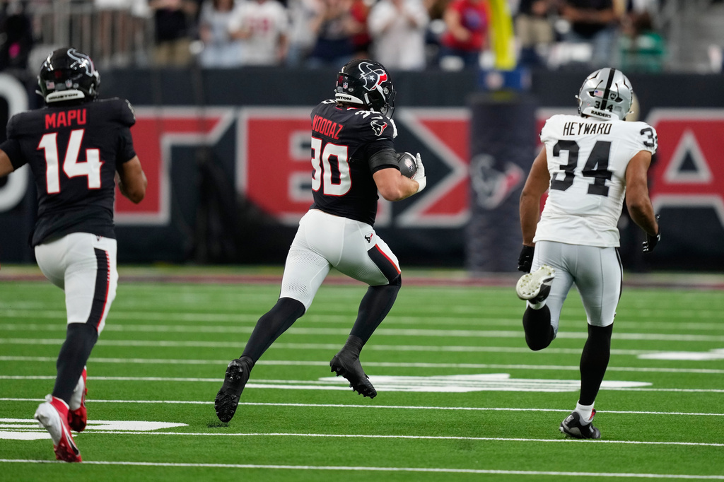 Houston Texans linebacker Wade Woodaz (30) returns an interception for a touchdown against the Las Vegas Raiders during the first half of an NFL preseason football game, Thursday, Aug. 20, 2026, in Houston. (AP Photo/David J. Phillip)