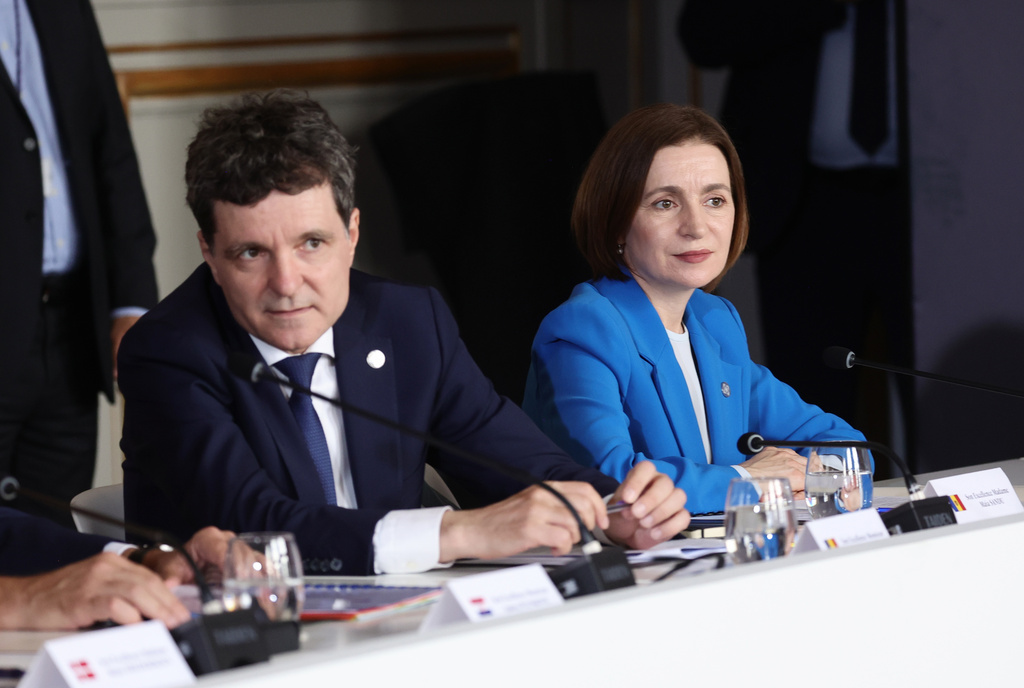 Romanian President Nicusor Dan, left, and Moldovan President Maia Sandu attend the Coalition of the Willing summit on security guarantees for Ukraine, at the Hotel des Invalides in Paris, Monday, July 2026. (Teresa Suares/Pool Photo via AP)