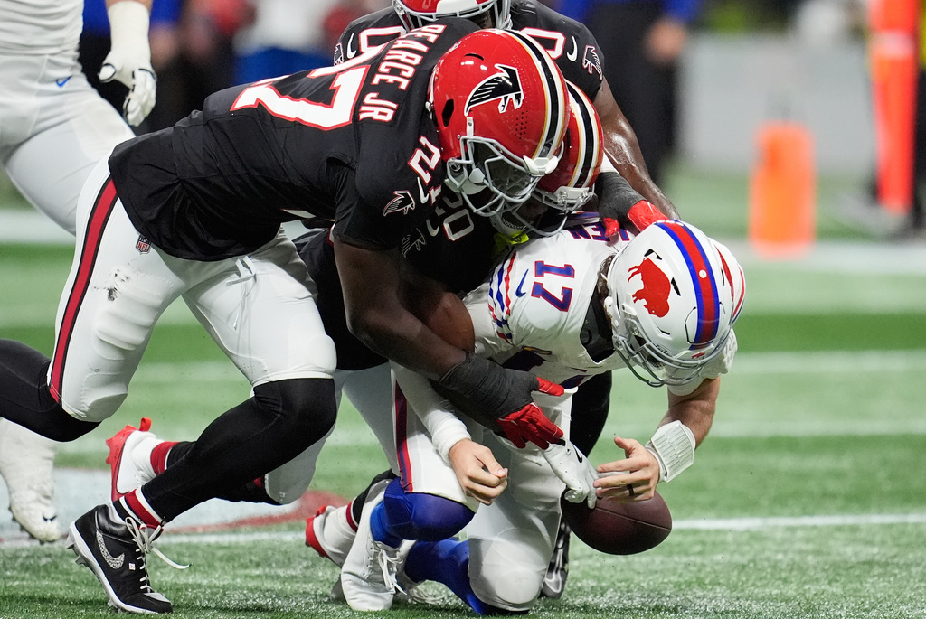 Buffalo Bills quarterback Josh Allen (17) is sacked by Atlanta Falcons cornerback Dee Alford (20) and defensive end James Pearce Jr. (27) during the first half of an NFL football game, Monday, Oct. 13, 2025, in Atlanta. (AP Photo/Mike Stewart)