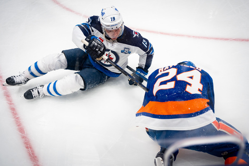 Winnipeg Jets center Jonathan Toews (19) collides with New York Islanders defenseman Scott Mayfield (24) during the first period of an NHL hockey game, Monday, Oct. 13, 2025, in Elmont, N.Y. (AP Photo/Angelina Katsanis) Winnipeg Jets center Jonathan Toews (19) collides with New York Islanders defenseman Scott Mayfield (24) during the first period of an NHL hockey game, Monday, Oct. 13, 2025, in Elmont, N.Y. (AP Photo/Angelina Katsanis)