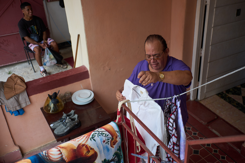 Choreographer Juan Miguel Mas sets up for his weekend garage sale to help supplement his modest income in Havana, Cuba, Saturday, May 9, 2026. (AP Photo/Ramon Espinosa)