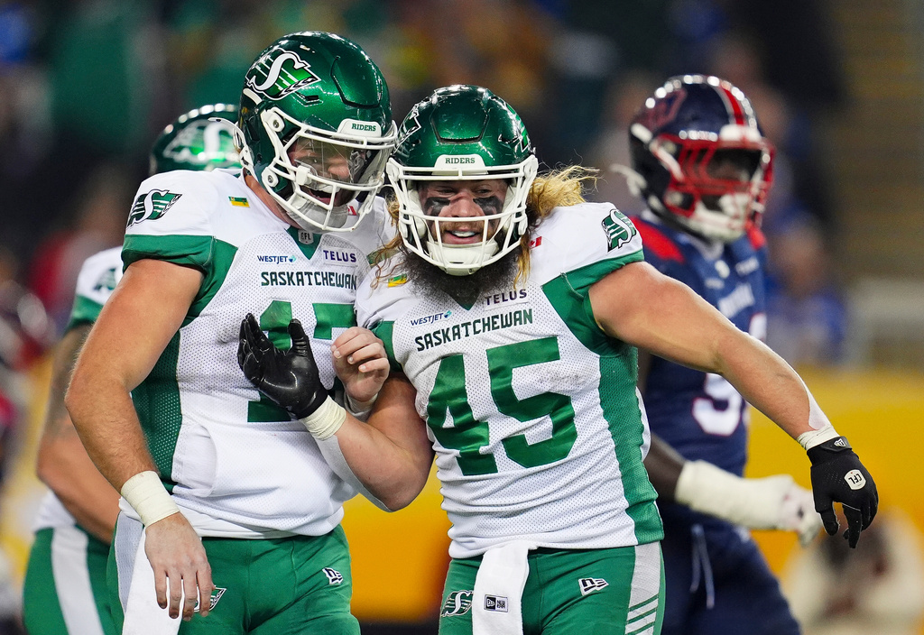 Saskatchewan Roughriders quarterback Tommy Stevens (17) celebrates his touchdown with teammate A.J. Ouellette (45) against the Montreal Alouettes during second half CFL football action in the Grey Cup in Winnipeg, Manitoba, Sunday, Nov. 16, 2025. (Frank Gunn/The Canadian Press via AP)