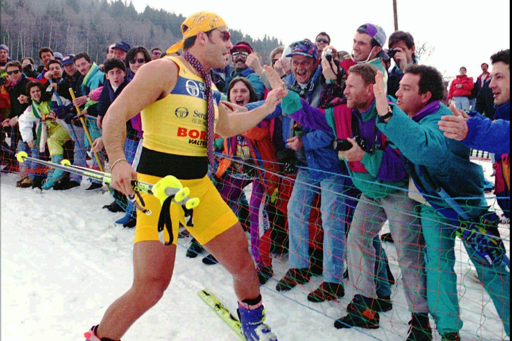 FILE - World Cup overall winner Alberto Tomba salutes his fans wearing shorts and a tie before the prize-giving ceremony in Bormio, Italy, March 19, 1995. (AP Photo/Alessandro Trovati, File)