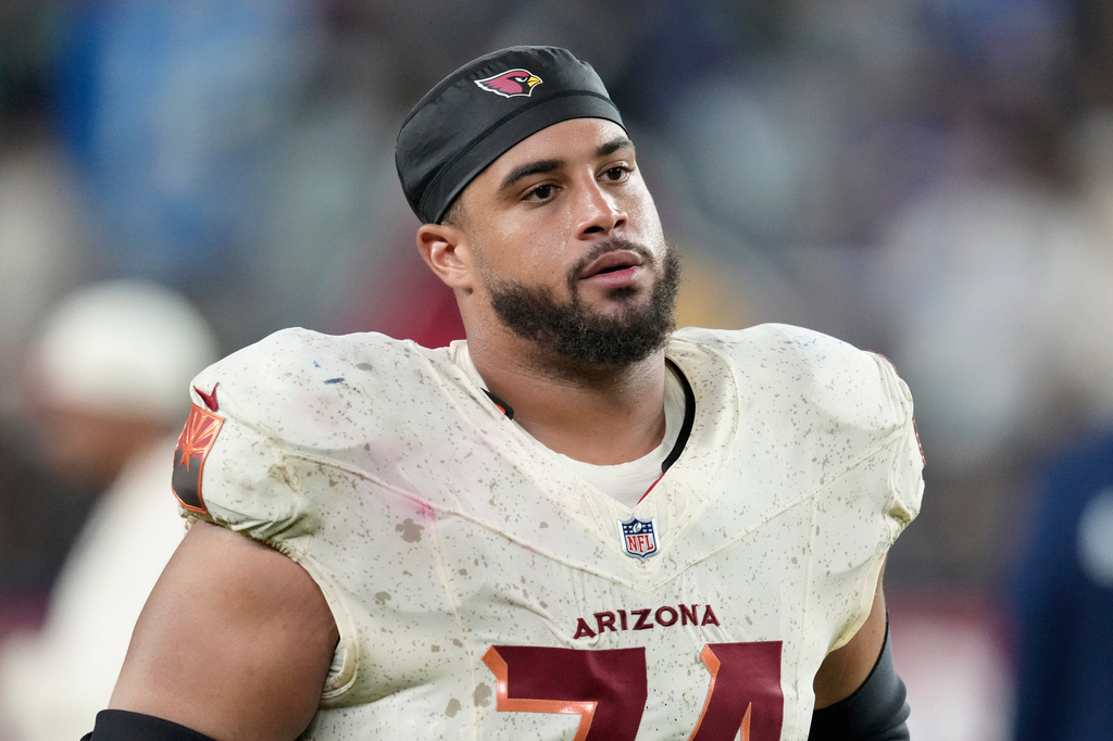 FILE - Arizona Cardinals guard Isaiah Adams walks off the field after an NFL football game against the Seattle Seahawks, Sept. 25, 2025, in Glendale, Ariz. (AP Photo/Ross D. Franklin, File)