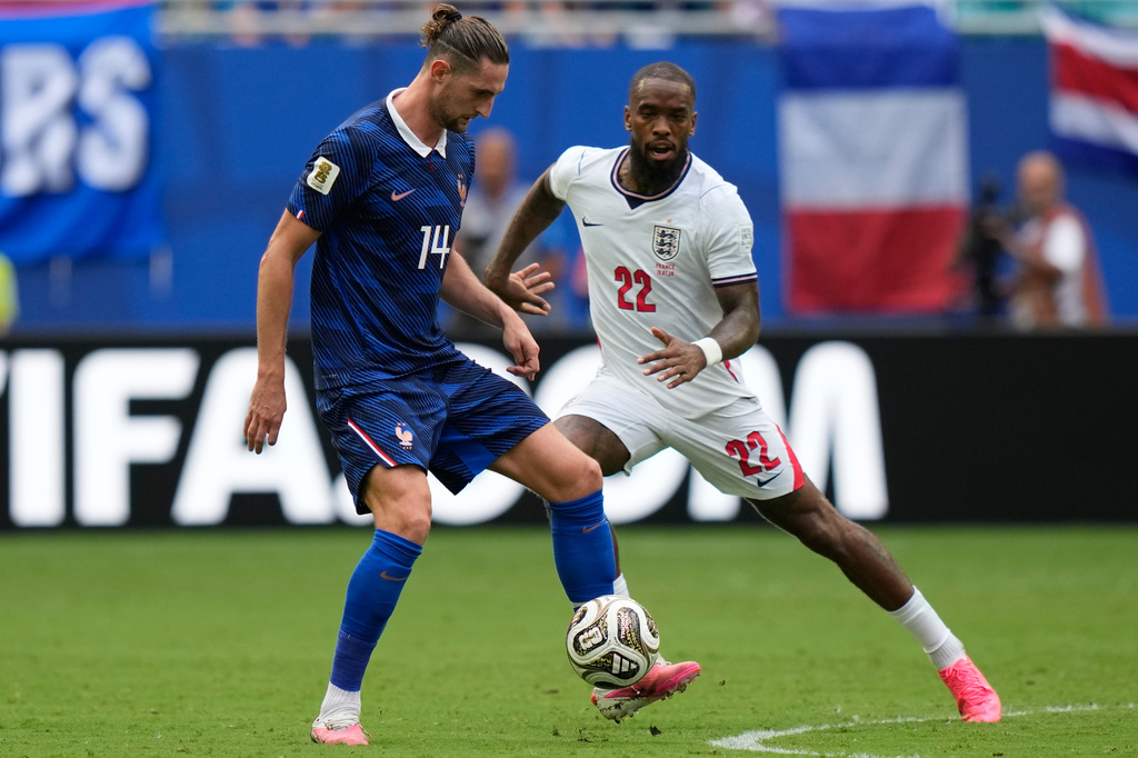 France's Adrien Rabiot (14) controls the ball past England's Ivan Toney (22) during the World Cup third-place playoff soccer match between France and England in Miami Gardens, Fla., Saturday, July 18, 2026. (AP Photo/Lynne Sladky)