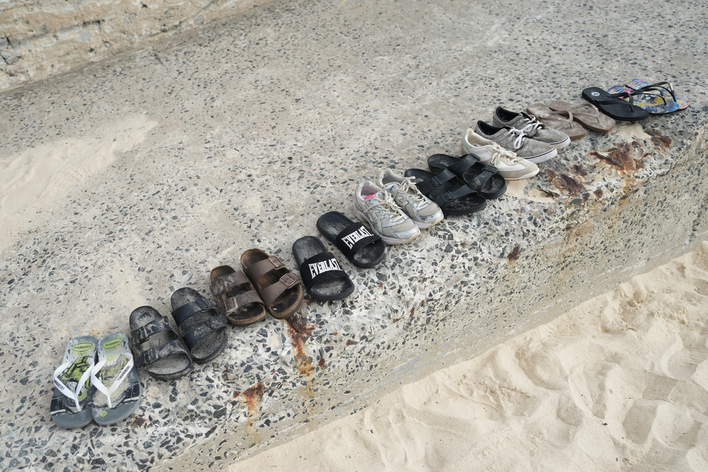Shoes sit lined up following a shooting the day prior at Sydney's Bondi Beach, Monday, Dec. 15, 2025. (AP Photo/Mark Baker)