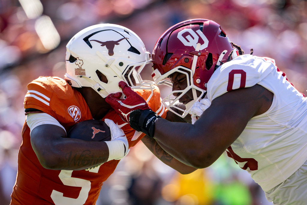 Oklahoma defensive lineman David Stone, right, brings down Texas running back Quintrevion Wisner, left, on a run during the first half of an NCAA college football game Saturday, Oct. 11, 2025, in Dallas. (AP Photo/Jeffrey McWhorter)