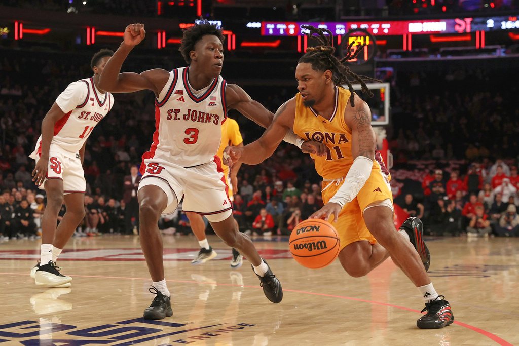 Iona's CJ Anthony (11) drives to the basket against St. John's Joson Sanon (3) during the first half of an NCAA college basketball game Saturday, Dec. 13, 2025, in New York. (AP Photo/Pamela Smith)