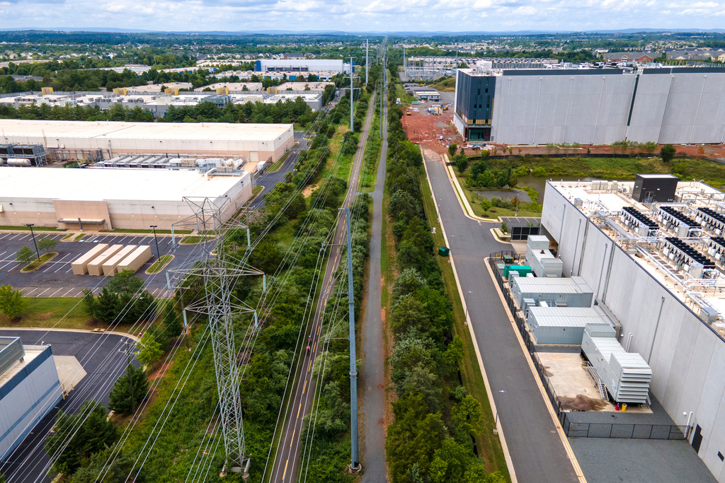 FILE - High-voltage transmission lines provide electricity to data centers in Ashburn in Loudon County, Virginia, on July 16, 2023. (AP Photo/Ted Shaffrey, File)
