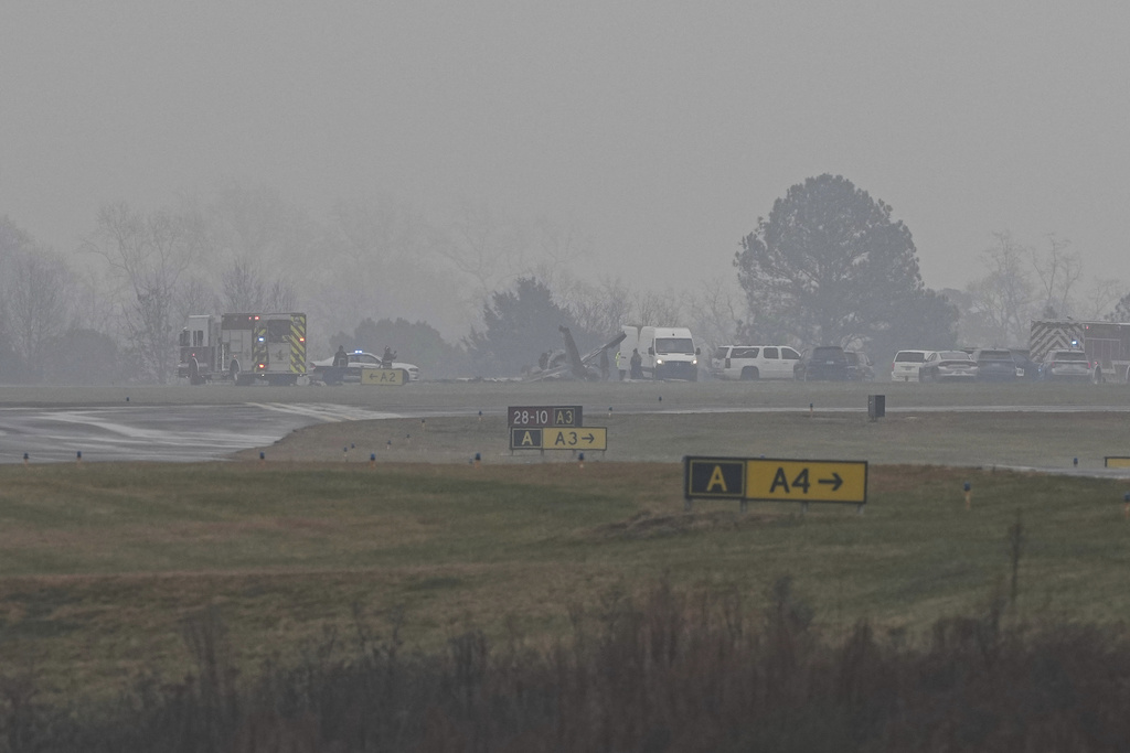 First responders tend to the scene of a reported plane crash at a regional airport in Statesville, N.C., Thursday, Dec. 18, 2025. (AP Photo/Matt Kelley)