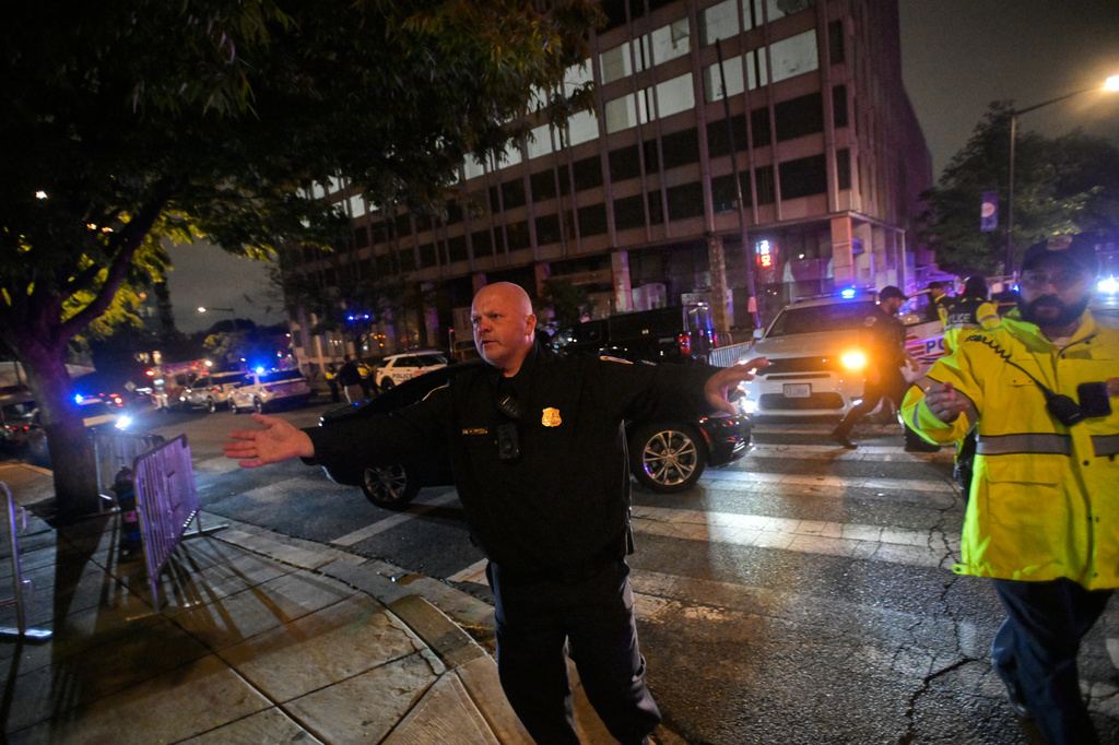 Law enforcement officials direct traffic outside the White House Correspondents Dinner, Saturday, April 25, 2026, in Washington. (AP Photo/Rod Lamkey, Jr.)