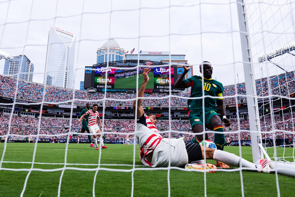 Senegal forward Sadio Mané (10) scores against United States defender Miles Robinson, bottom, during the second half of an international friendly soccer match Sunday, May 31, 2026, in Charlotte, N.C. (AP Photo/Scott Kinser)