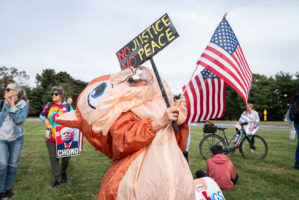 An attendee inflates their costume during a No Kings protest, Saturday, Oct. 18, 2025, in Washington. (AP Photo/Allison Robbert)