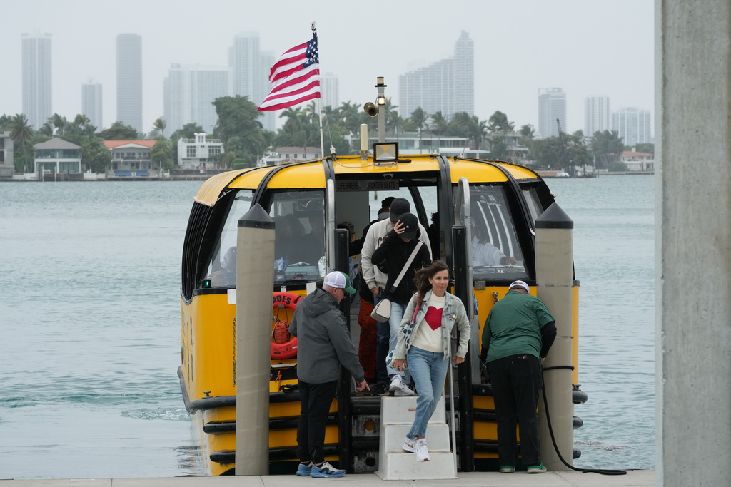 Passengers disembark at the Maurice Gibb Memorial Park, after traveling from the city of Miami, Wednesday, Jan. 21, 2026, in Miami Beach, Fla. (AP Photo/Marta Lavandier)