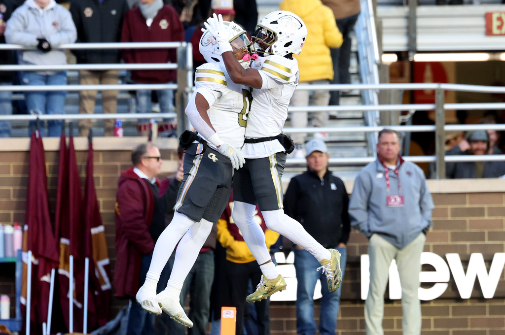 Georgia Tech running back Malachi Hosley, left, and wide receiver Malik Rutherford, right, celebrate after Hosley's touchdown during the first half of an NCAA college football game against Boston College, Saturday, Nov. 15, 2025, in Boston. (AP Photo/Mark Stockwell)