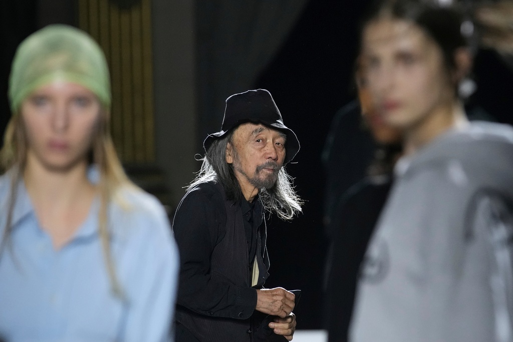 Designer Yohji Yamamoto works with models prior to the Yamamoto Spring/Summer 2026 collection presented in Paris, Friday, Oct. 3, 2025. (AP Photo/Christophe Ena)