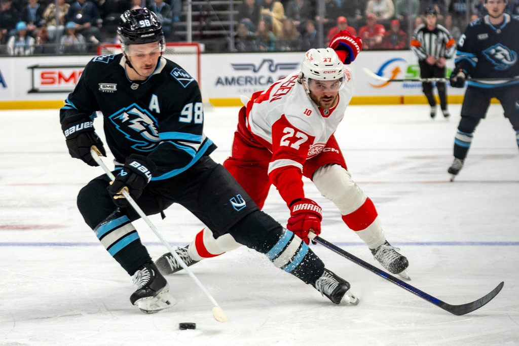Detroit Red Wings center Michael Rasmussen (27) goes for the puck along with Utah Mammoth defenseman Mikhail Sergachev (98) during the second period of an NHL hockey game, Wednesday, Feb. 4, 2026, in Salt Lake City. (AP Photo/Rick Egan)