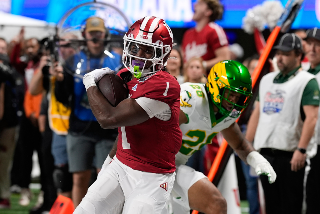Indiana running back Roman Hemby (1) carries during the first half of the Peach Bowl NCAA college football playoff semifinal against Oregon, Friday, Jan. 9, 2026, in Atlanta. (AP Photo/Mike Stewart)