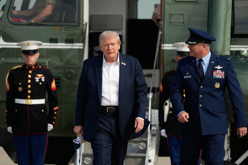 President Donald Trump, center, is escorted by Air Force Col. Christopher M. Robinson, commander of the 89th Airlift Wing, right, as he walks from Marine One to board Air Force One, Friday, Sept. 26, 2025, at Joint Base Andrews, Md. (AP Photo/Alex Brandon) President Donald Trump, center, is escorted by Air Force Col. Christopher M. Robinson, commander of the 89th Airlift Wing, right, as he walks from Marine One to board Air Force One, Friday, Sept. 26, 2025, at Joint Base Andrews, Md. (AP Photo/Alex Brandon)
