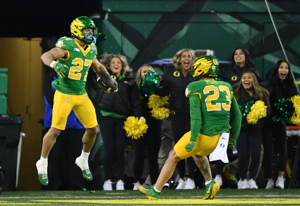 Oregon running back Jayden Limar (27) celebrates after his blocked punt return for a touchdown against James Madison with linebacker Brayden Platt (23) during the second half in the first round of the NCAA College Football Playoff, Saturday, Dec. 20, 2025, in Eugene, Ore. (AP Photo/Mark Ylen)