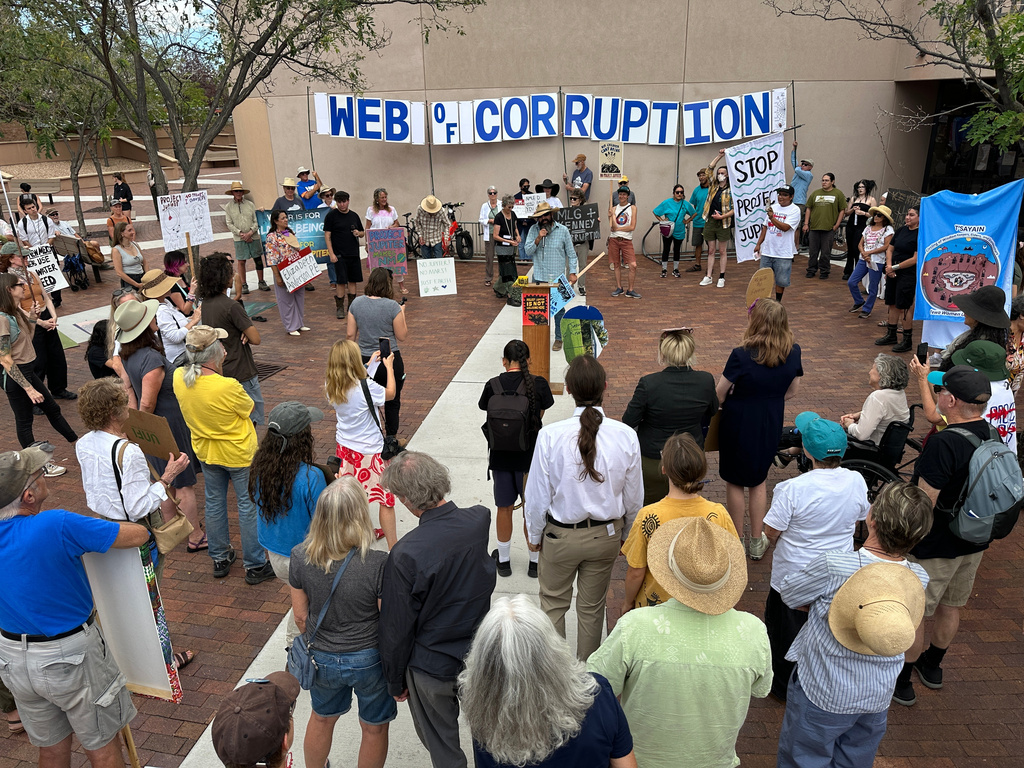 Protesters gather outside the New Mexico Environment Department to voice opposition to the Project Jupiter data center during a demonstration in Santa Fe, N.M., Friday, Aug. 21, 2026. (AP Photo/Susan Montoya Bryan)