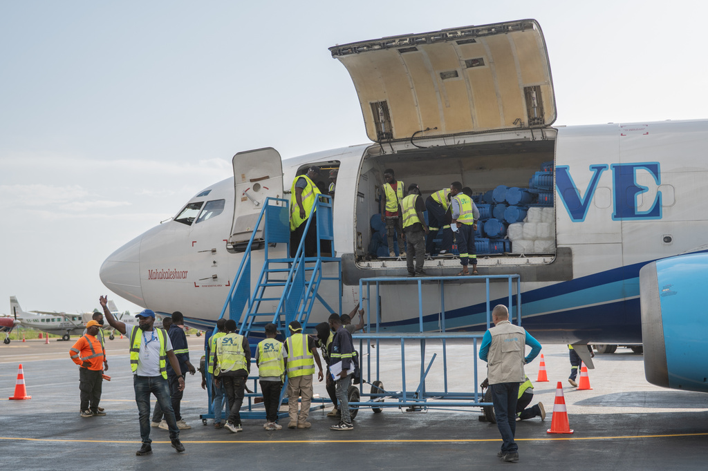 People offload a shipment of more than 15 tonnes of supplies donated by UNICEF as part of the response to the Ebola virus outbreak at Bunia National Airport in Bunia, Congo, Tuesday, May 19, 2026. (AP Photo/Moses Sawasawa)