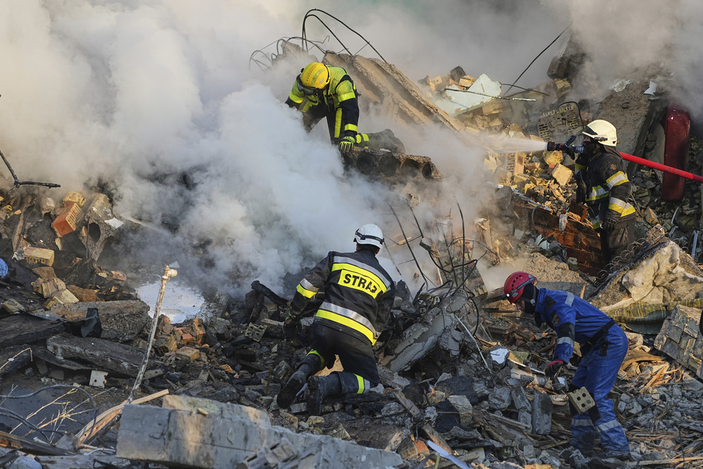Firefighters work at the site of a burning building after a Russian attack in Kyiv, Ukraine, Thursday, Aug. 28, 2025. (AP Photo/Efrem Lukatsky)