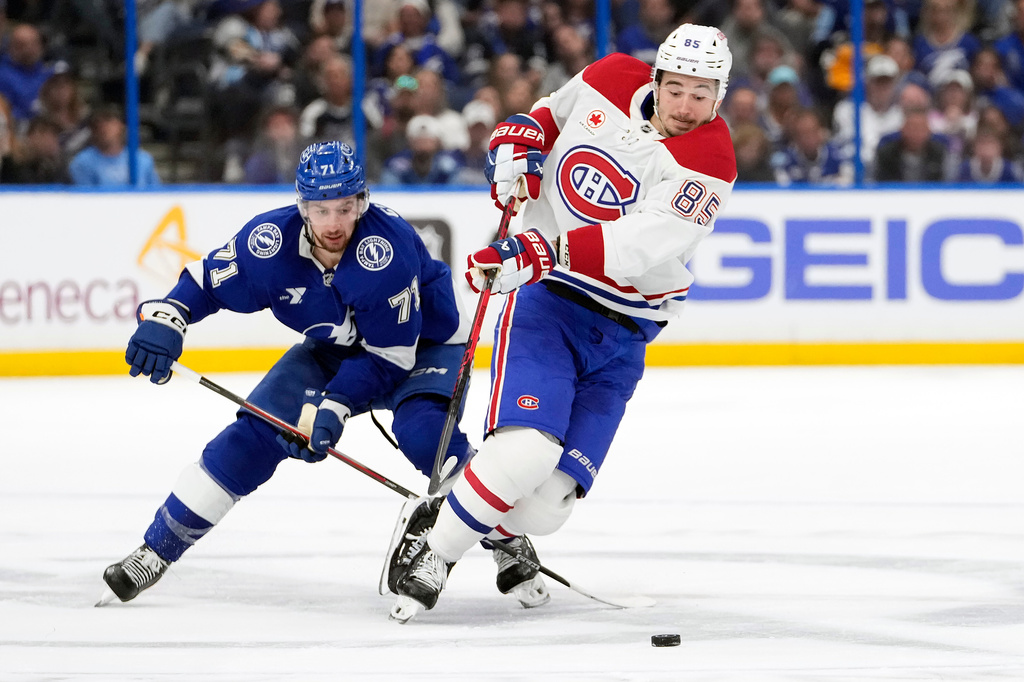 Montréal Canadiens left wing Alexandre Texier (85) gets tripped up by Tampa Bay Lightning center Anthony Cirelli (71) during the first period in Game 2 of an NHL hockey Stanley Cup first-round playoff series, Tuesday, April 21, 2026, in Tampa, Fla. (AP Photo/Chris O'Meara)