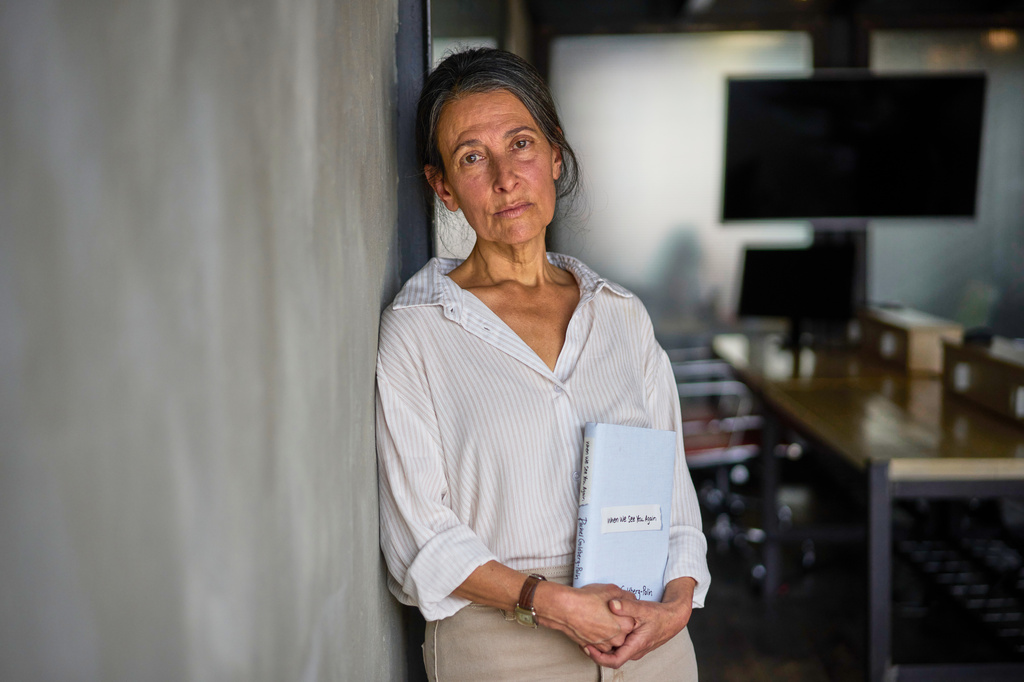 Rachel Goldberg-Polin, whose 23-year-old son, Hersh, was kidnapped on Oct. 7, 2023 Hamas cross border attack on Israel and killed in Gaza nearly a year later, poses for a photo with her new book "When We See You Again," in Jerusalem, Wednesday, April 15, 2026. (AP Photo/Ohad Zwigenberg)