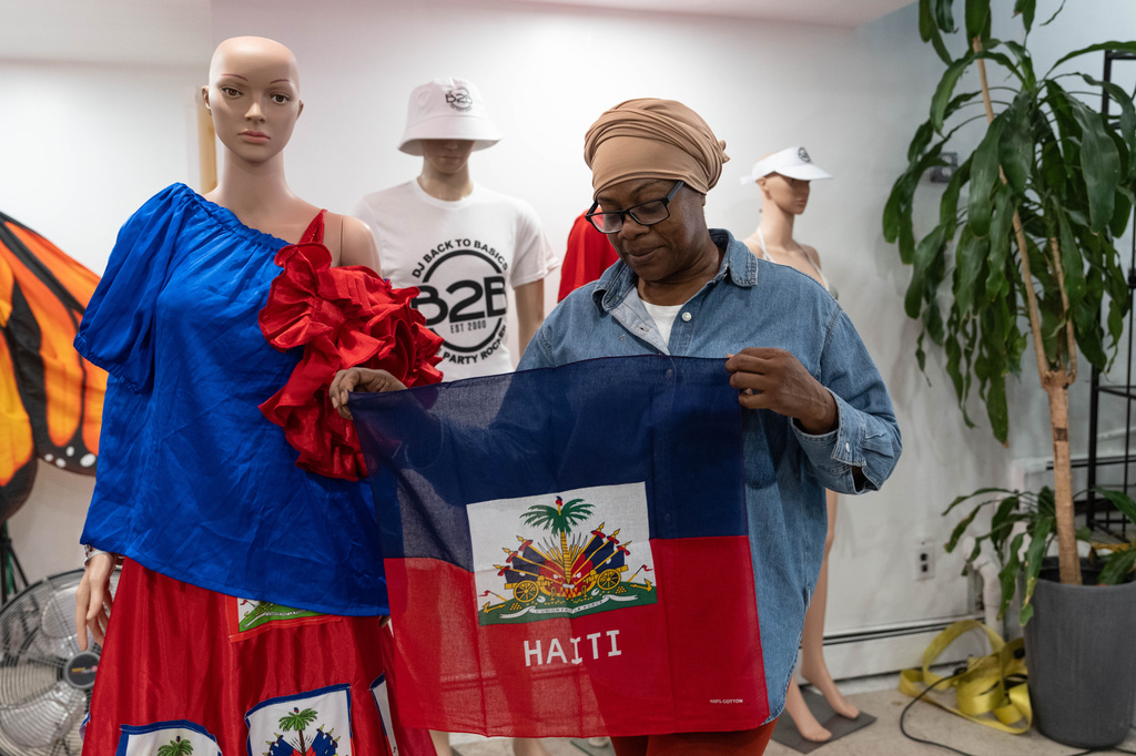 Haitian-born Edwina Paul holds Haitian flag ahead of the West Indian Day Parade, Thursday, Sept. 3, 2026, in the Brooklyn borough of New York. (AP Photo/Adam Gray)