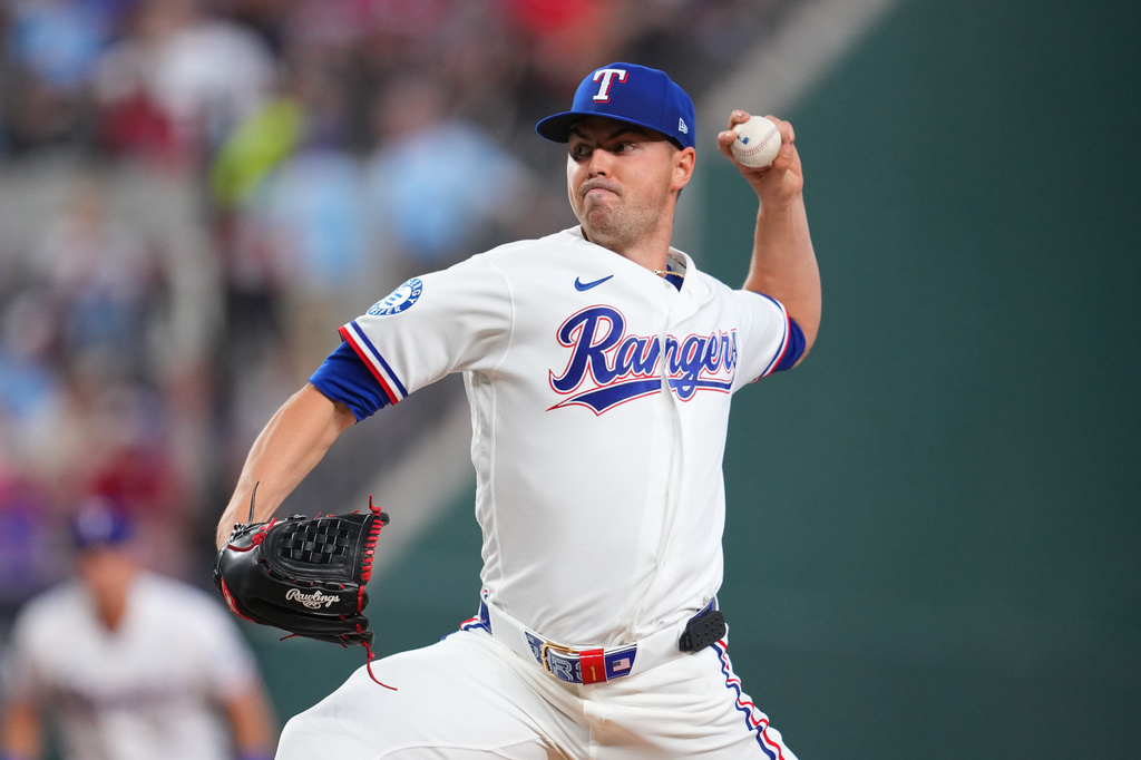 Texas Rangers starting pitcher MacKenzie Gore throws a pitch to the Cincinnati Reds during the second inning of the Rangers' home-opener baseball game Friday, April 3, 2026, in Arlington, Texas. (AP Photo/Julio Cortez)