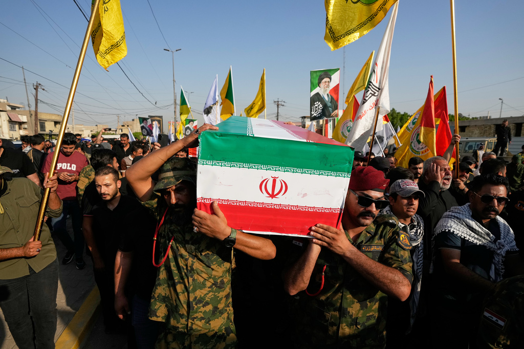 Mourners carry the coffin of an Iranian adviser draped in the Iranian flag during a group funeral for Iranian advisers and Popular Mobilization Forces fighters killed in airstrikes on bases belonging to Iraq's Popular Mobilization Forces, a coalition of predominantly Shiite militias that includes Iran-backed groups, in Mosul, Iraq, Wednesday, July 29, 2026. (AP Photo/Hadi Mizban) ADDITION: Updates caption to identify the funeral as being for Iranian advisers and Popular Mobilization Forces fighters.