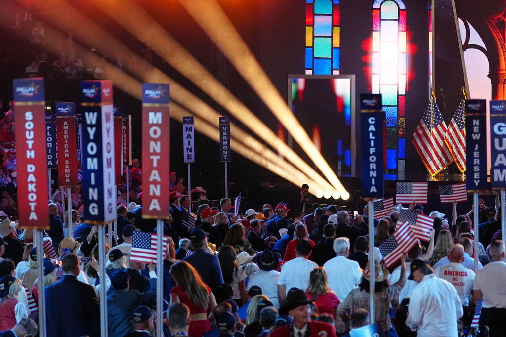 People hold signs at the Republican convention, Thursday, Sept. 10, 2026, in Dallas. (AP Photo/Julia Demaree Nikhinson)
