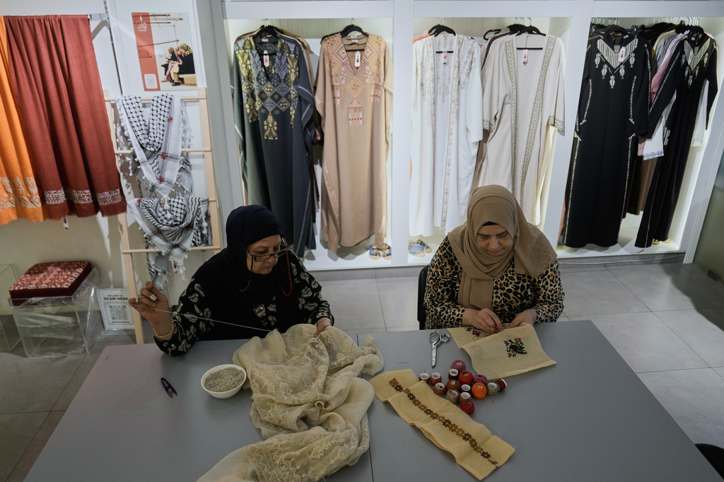 Palestinian weavers Rula Barakeh, right, and Samira Nasser work on handmade embroidered pieces at the Inaash Association embroidery workshop in Beirut, Tuesday, May 19, 2026. (AP Photo/Bilal Hussein)