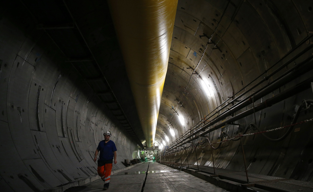 FILE - An engineer walks inside a Turin-Lyon high-speed rail tunnel (TAV) in Saint Martin La Porte, France, Feb. 12, 2019. (AP Photo/Antonio Calanni, File)