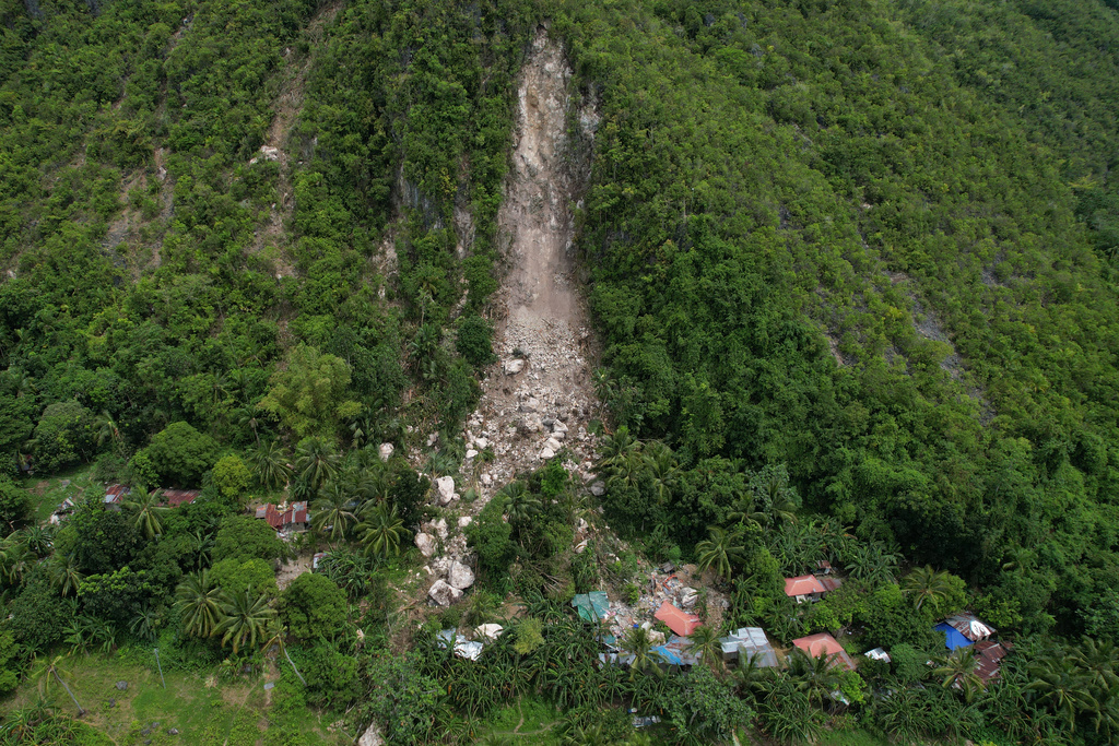 Damaged homes lie after a landslide caused by Tuesday's strong earthquake killed some people sleeping in their hillside homes, Thursday, Oct. 2, 2025, in Bogo city, Cebu Province, Central Philippines. (AP Photo/Aaron Favila)