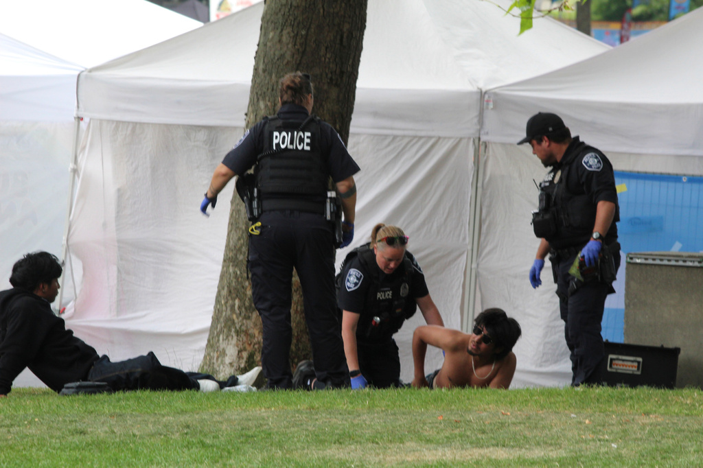Police attend to a person after a shooting at Seattle Center during the Bite of Seattle food festival Sunday, July 26, 2026, in Seattle, Wash. (Estan Wakonabo via AP)
