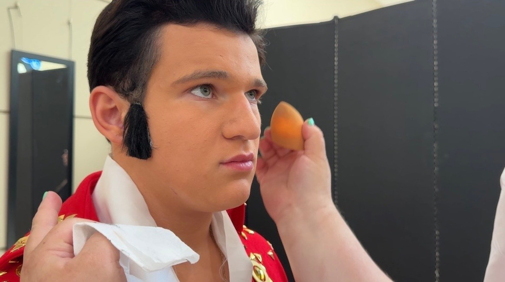 In this screenshot from video, Charles Session, 15, holds still while he gets his makeup done ahead of the Tupelo Elvis Festival's youth tribute artists competition on June 4, 2026, in Tupelo, Miss. (AP Photo/Sophie Bates)