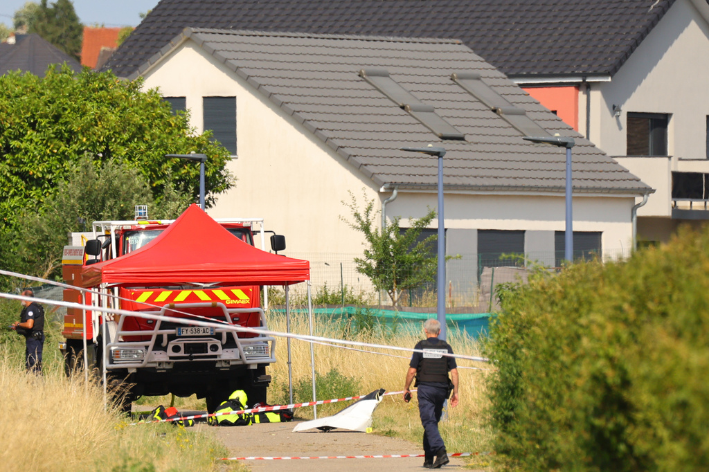 Police officer stands near the site where a skydiving plane crashed in Tomblaine northeastern France, killing all 11 people on board, Sunday, June 28, 2026. (AP Photo/Antonin Utz)