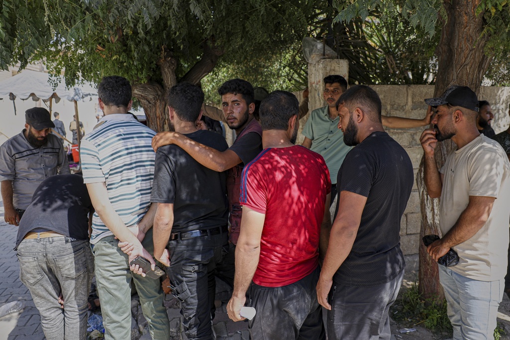 Young Kurdish men line up to sign up to join Syrian government's General Security forces at a police station in Afrin, Syria, an area in the country's north from which Kurds were forcibly displaced years ago, Thursday Aug. 21, 2025. (AP Photo/Omar Albam)